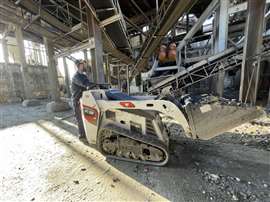 A man using the Bobcat MT55 mini track loader at Santos Jorge's recycling plant