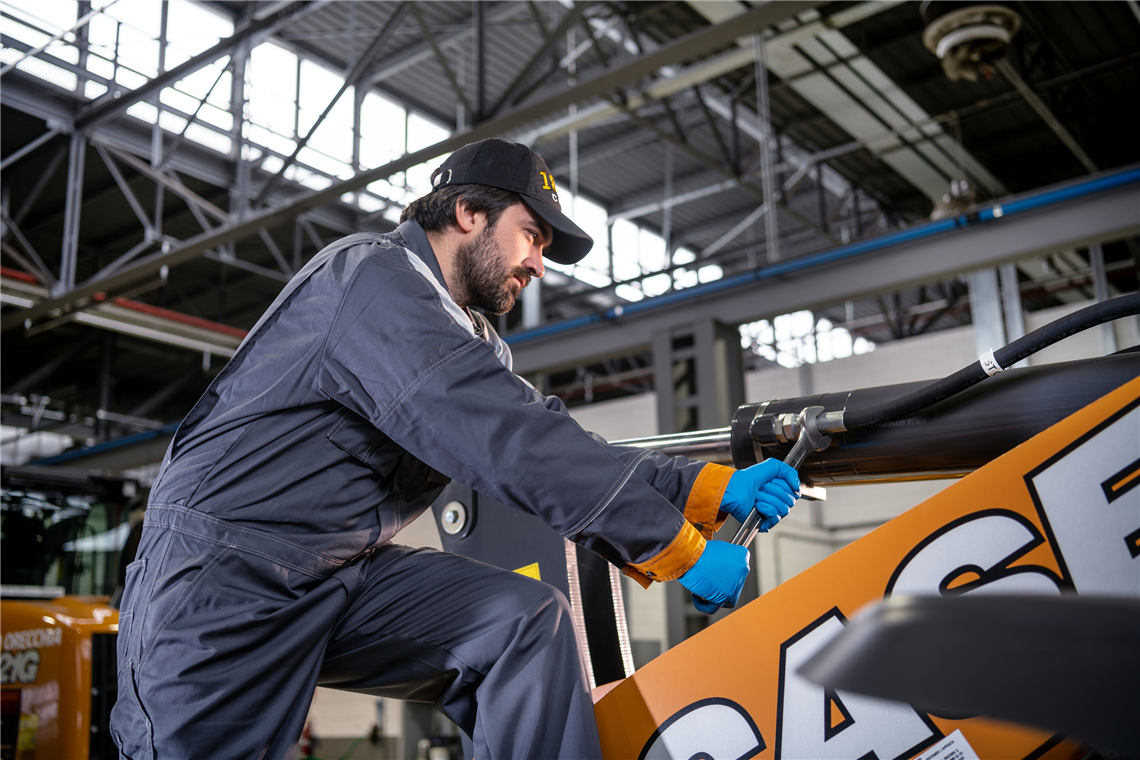 A technician carries out maintenance on a Case machine