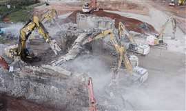 Demolition excavators taking down the two-span M42 bridge