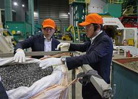 Japanes Prime Minister Fumio Kishida looks at recycled metal