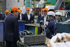Japanes Prime Minister Fumio Kishida speaks with staff at the Imizu Recycle Centre in Toyama, Japan