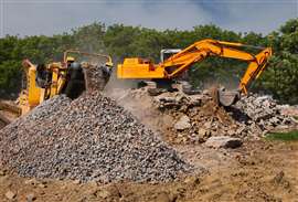 An excavator and crusher processing demolition waste
