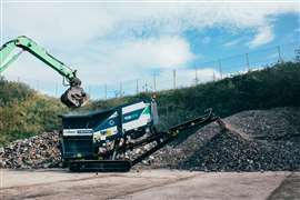 An excavator feeds the Terex Ecotec TDS 815 Shredder with rubble