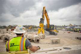 A vistor watching the Liebherr excavator in the Demo Operator Challenge