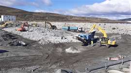 Slab debris is hammered by excavators and loaded into a mobile crusher