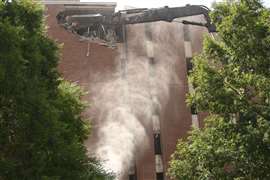 A high reach excavator demolishing part of Galloway Hall at UCNW