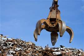 a crane grabber up on the metal heap
