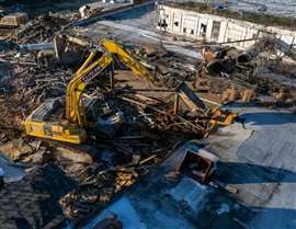 A Sessler Wrecking excavator at work at the former Burlington Industries mill