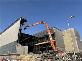 A high reach excavator tearing down the metal structure of the Sizewell A Turbine Hall in February 2025