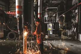 A worker carrying out hot cutting works inside the plant