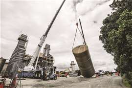 A mobile crane lifting a silo tank at the plant