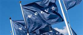 Blue flags with white Volvo logo blowing in the wind