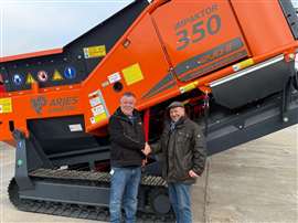 Colin Wilkie, business development manager at AGGPRO (left) with Norbert Hammel, founder of ARJES Impaktor shaking hands in front of a mobile shredder
