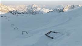 Snowy mountain with ski lift taken down