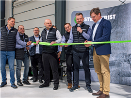 Grop of people watching teh CEO cutting the ribbon