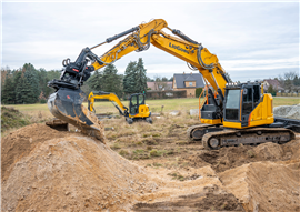 Yellow excavator working with gravel