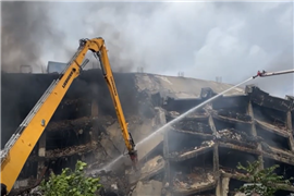 Demolition team helps tackle massive factory fire