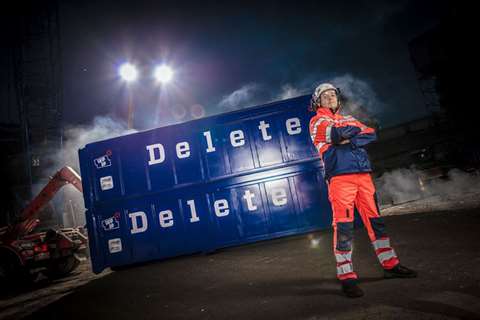 Demolition worker in front of Delete branded container