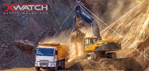 An excavator loading materials into a truck at a quary