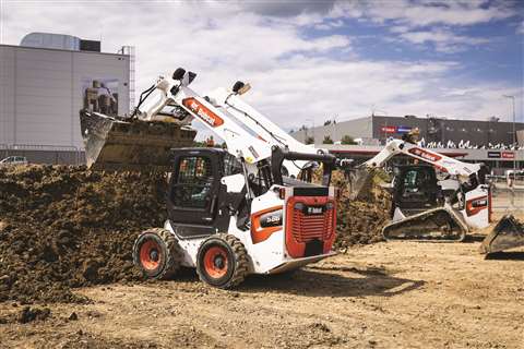 Two Bobcat loaders sit unmanned on a construction site