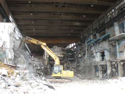 A Lee Group excavator at work inside one of the paper mill structures. The amount of process plant t