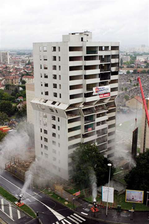 Jacks position inside the building push out the concrete panels