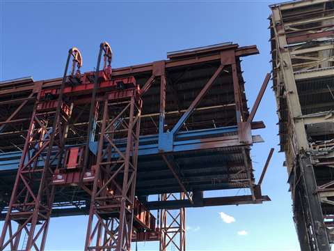 The steel and concrete truss was lifted to check its weight before the supports were cut away to allow lowering