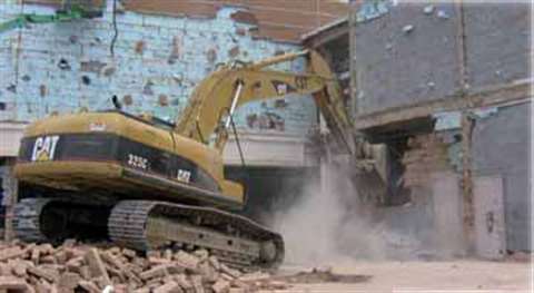 Prior to implosion, exterior masonry and the rear services concourse of the coliseum had to be remov
