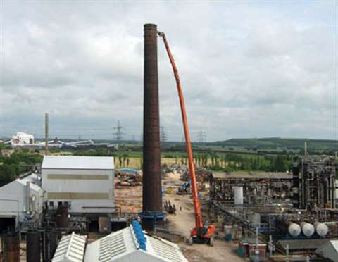 EDS used its 60 m high reach demolition rig to bring down a 50 m chimney at the Oxiris chemical fact
